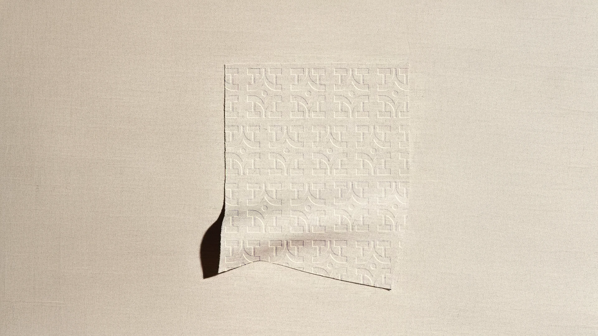 Cream textile with a subtle embossed monogram